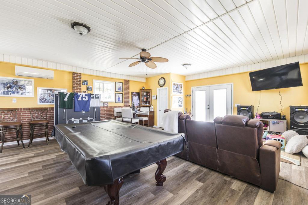 751 Findley Road Pinehurst, GA 31070 - Photo 34 of 47 a living room with furniture a flat screen tv and a large window