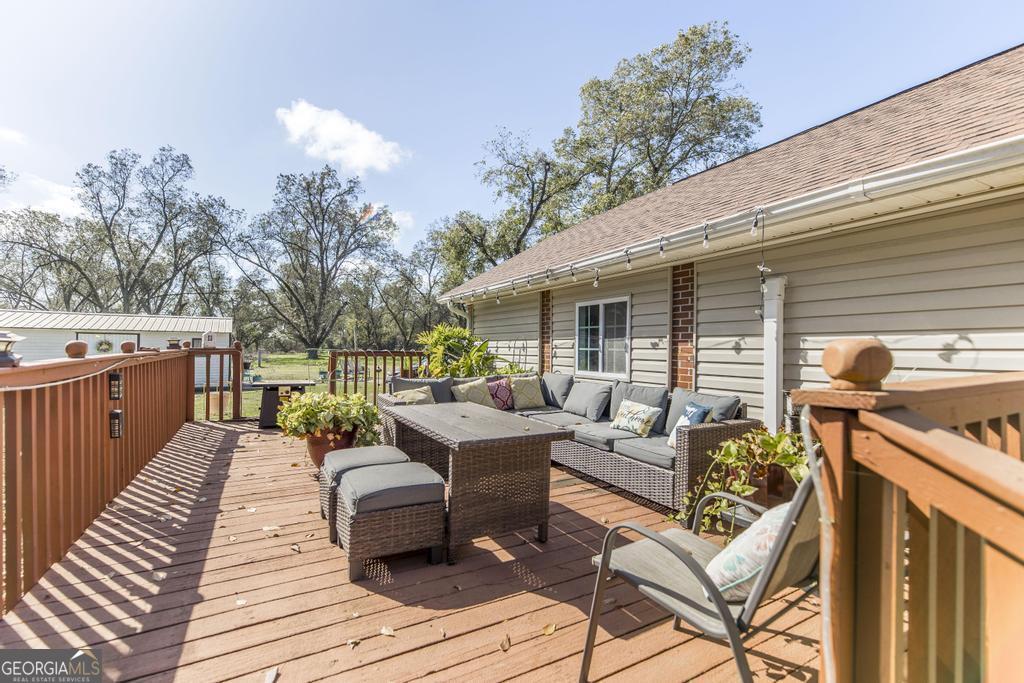 751 Findley Road Pinehurst, GA 31070 - Photo 36 of 47 a view of a patio with couches chairs and wooden floor