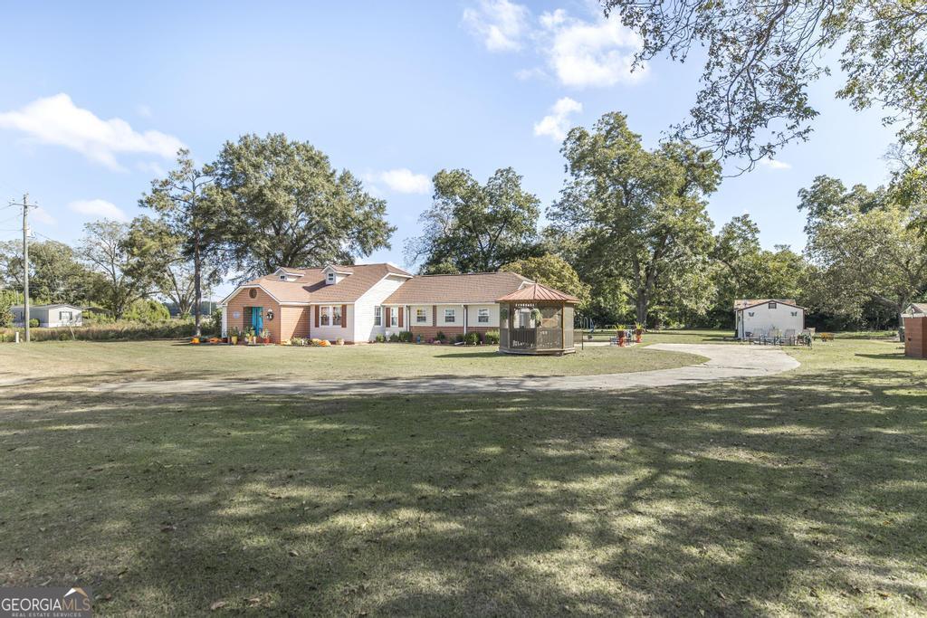751 Findley Road Pinehurst, GA 31070 - Photo 6 of 47 a view of a house with a yard