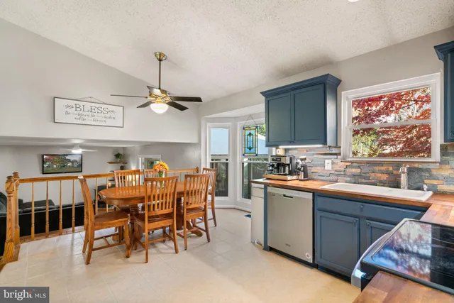 a kitchen with stainless steel appliances granite countertop a refrigerator stove and microwave