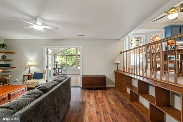 a living room with furniture a large window and a chandelier