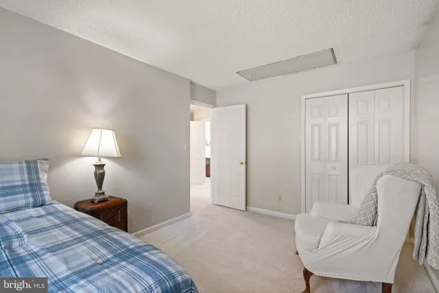 a bedroom with furniture and a lamp