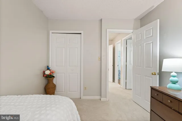 a bedroom with a bed and a lamp