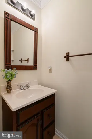 a bathroom with a sink vanity and a mirror