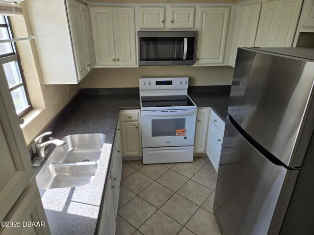 a kitchen with a refrigerator sink and stove