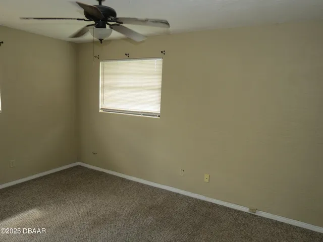 a view of a room with gym equipment and a glass door shower