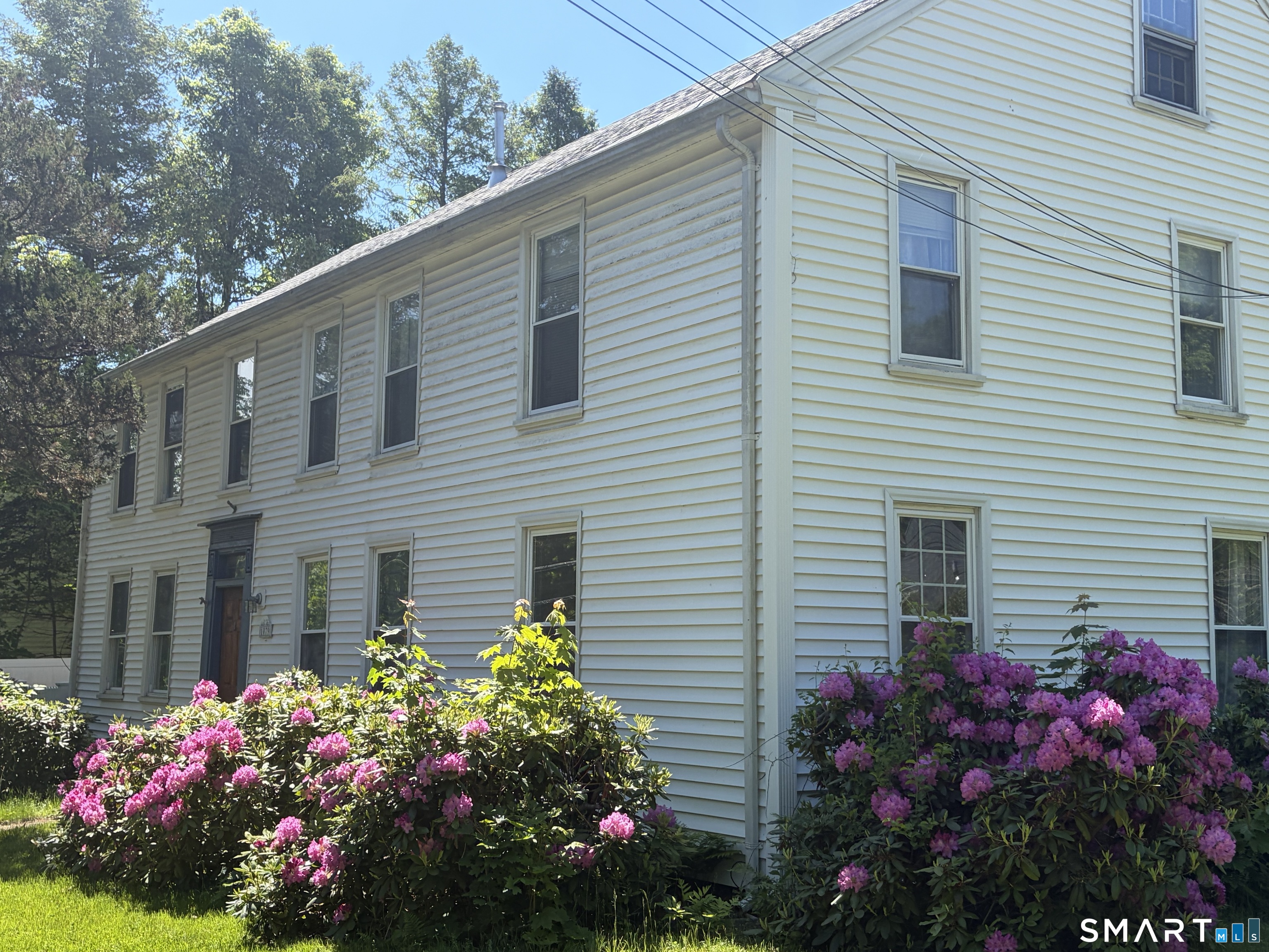 1079 Main Street Coventry, CT 06238 - Photo 3 of 19 a view of a flower garden in front of a house