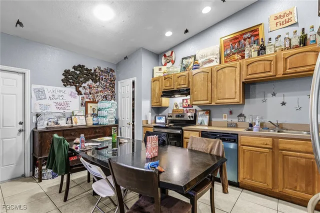 a kitchen with stainless steel appliances granite countertop a stove a sink dishwasher and cabinets with wooden floor