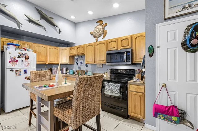 a kitchen with stainless steel appliances granite countertop a stove a sink dishwasher and a refrigerator with wooden floor