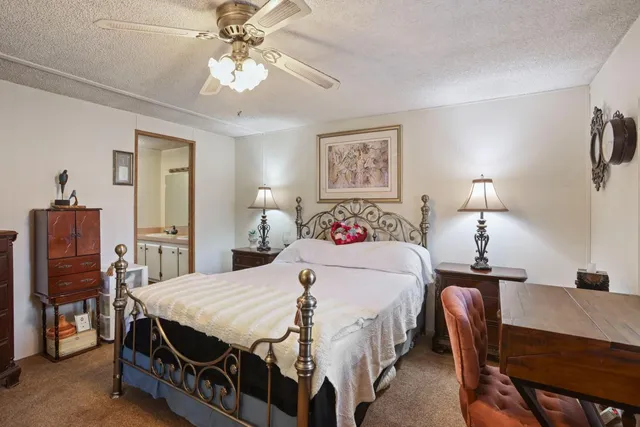 a bathroom with a sink a toilet and shower a mirror