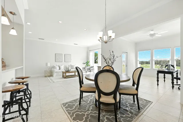 a view of a dining room with furniture and chandelier