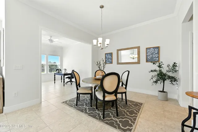 a view of a dining room with furniture and chandelier