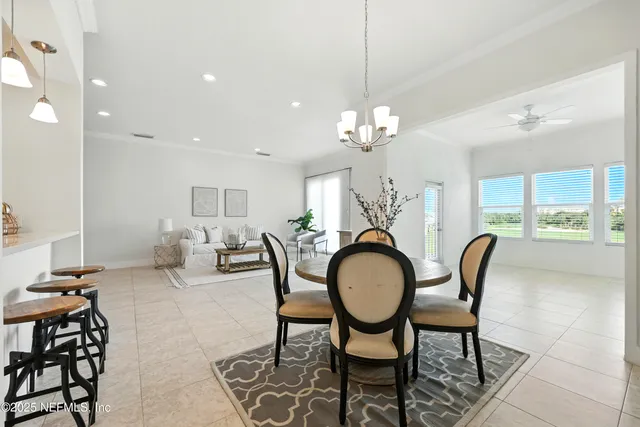 a view of a dining room with furniture and chandelier