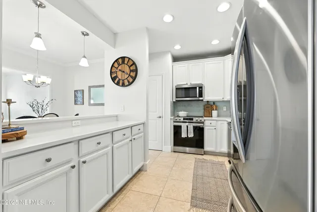 a kitchen with a sink cabinets and stainless steel appliances