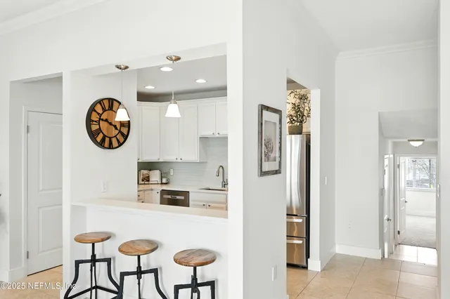a kitchen with stainless steel appliances granite countertop a refrigerator and a stove