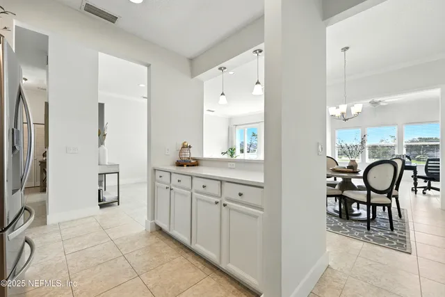 a spacious bathroom with a granite countertop sink a mirror and a bathtub
