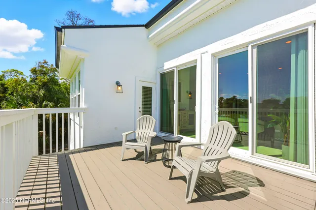 a view of balcony with wooden floor and fence