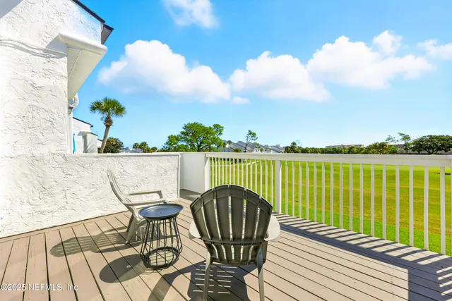 a view of a balcony with wooden floor