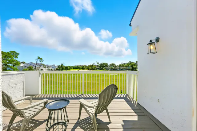 a view of a patio with couches table and chairs and potted plants