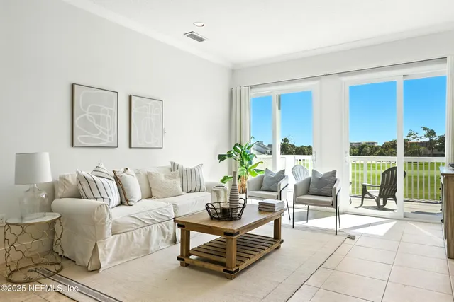 a living room with furniture and a floor to ceiling window