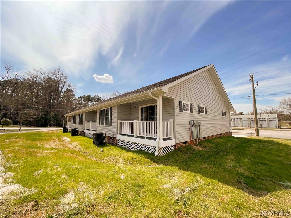 102-112 Maple Street Kenbridge, VA 23944 - Photo 8 of 11 a front view of a house with a yard table and chairs