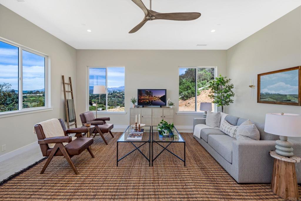 11231 West Lilac Road Valley Center, CA 92082 - Photo 1 of 1 a living room with furniture and a flat screen tv