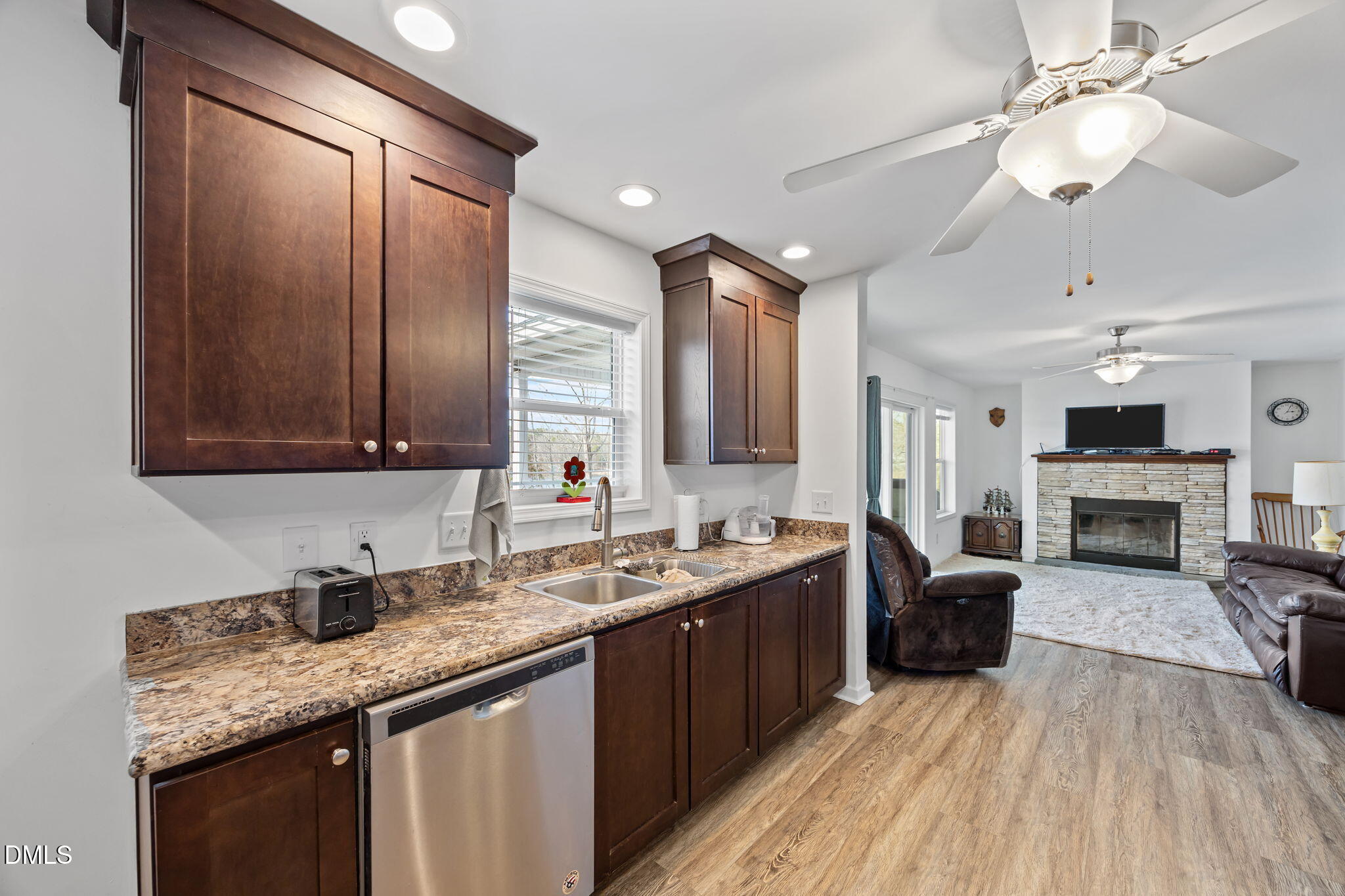 58 Lakefront Road Prospect Hill, NC 27314 - Photo 24 of 45 a large kitchen with stainless steel appliances granite countertop a sink dishwasher a stove and a refrigerator with wooden floor