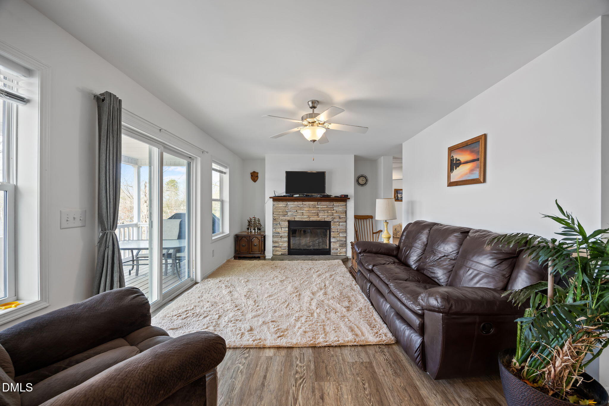 58 Lakefront Road Prospect Hill, NC 27314 - Photo 26 of 45 a living room with furniture a fireplace and a large window