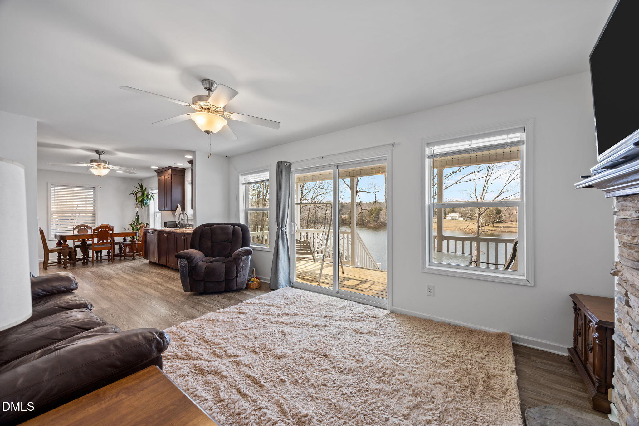 58 Lakefront Road Prospect Hill, NC 27314 - Photo 28 of 45 a living room with furniture a chandelier and a flat screen tv