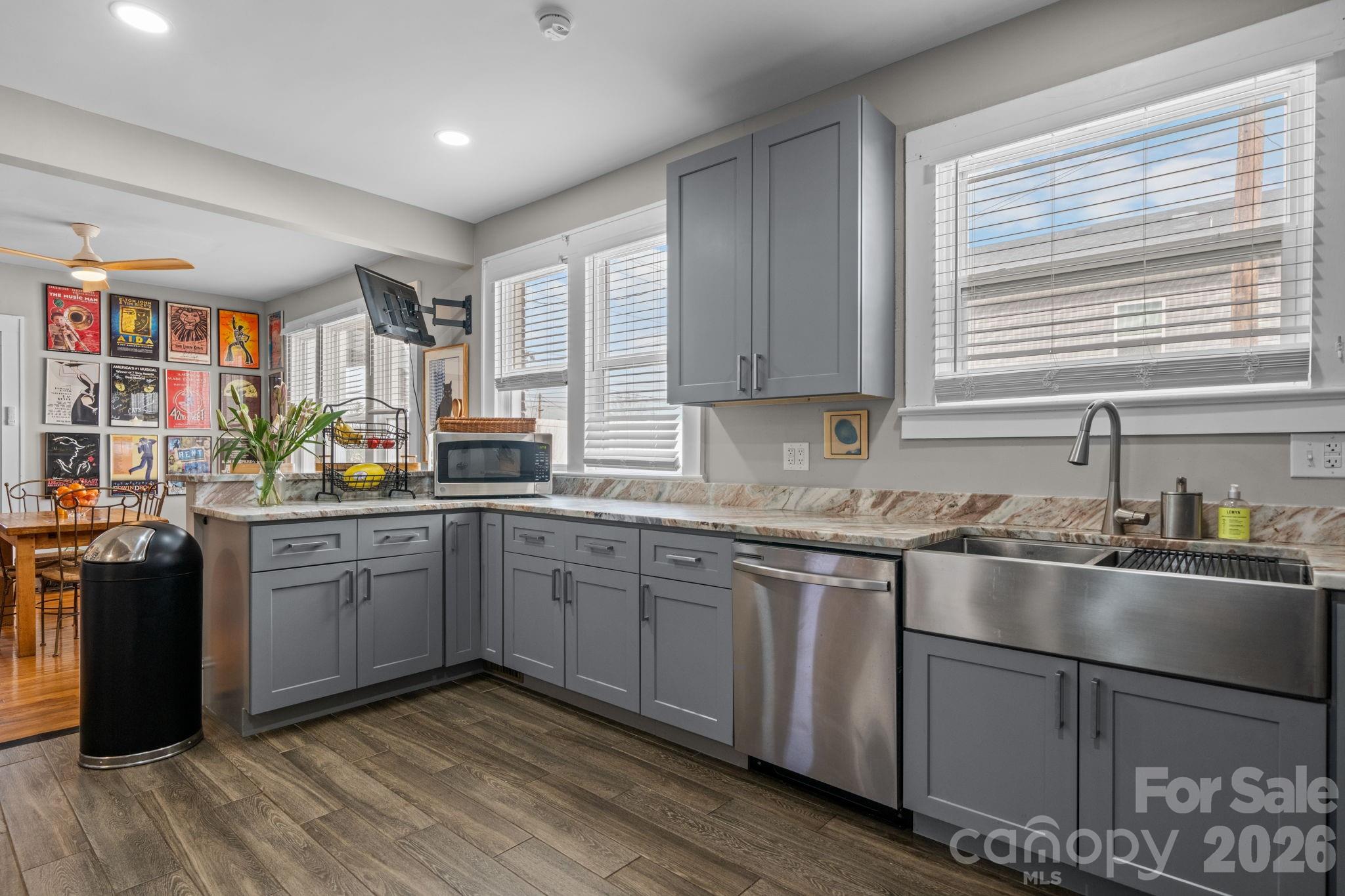 115 12th Street Southwest Hickory, NC 28602 - Photo 15 of 35 a kitchen with stainless steel appliances granite countertop a stove a sink dishwasher and a refrigerator