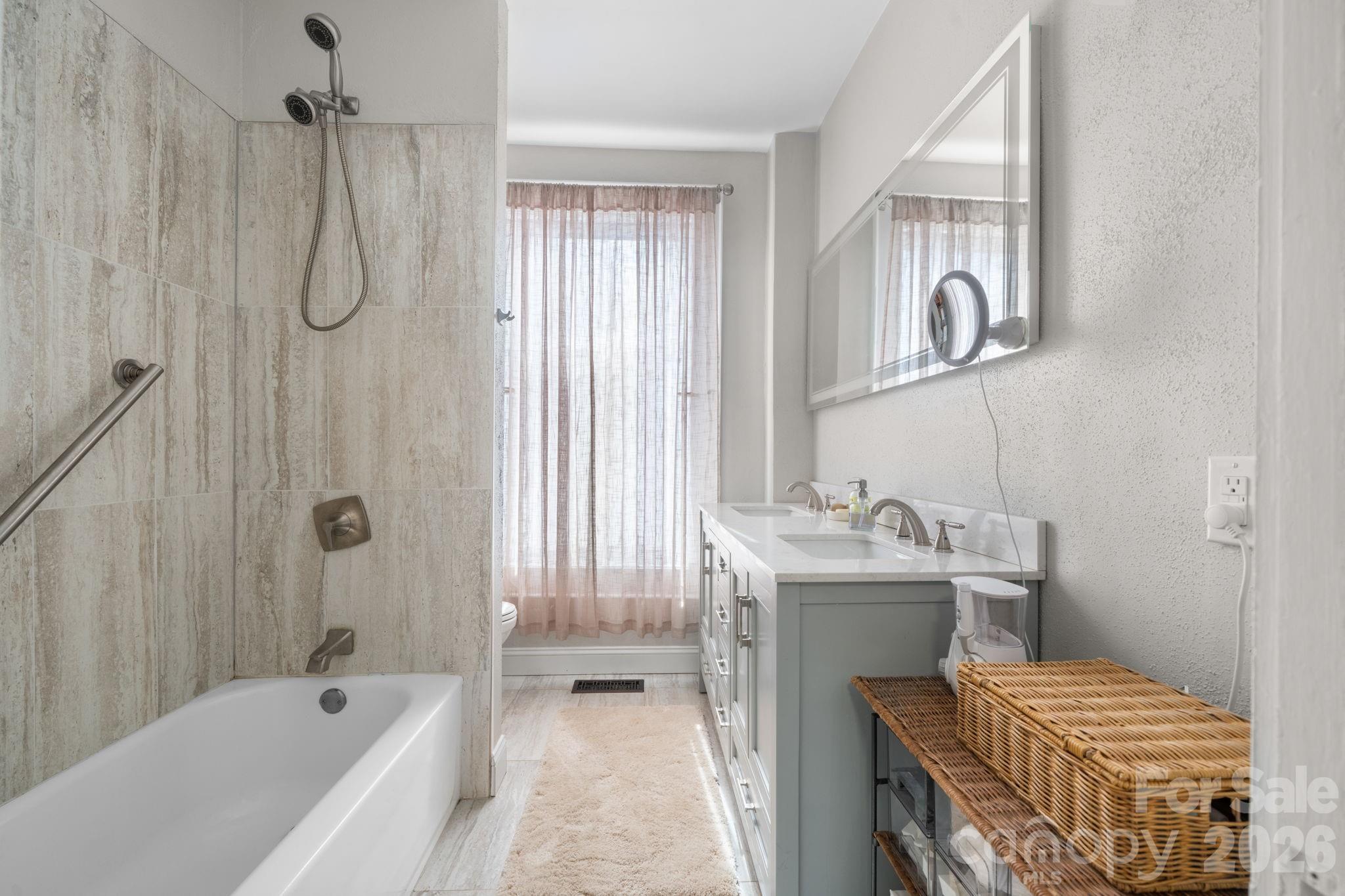 115 12th Street Southwest Hickory, NC 28602 - Photo 20 of 35 a bathroom with a granite countertop sink a toilet and shower