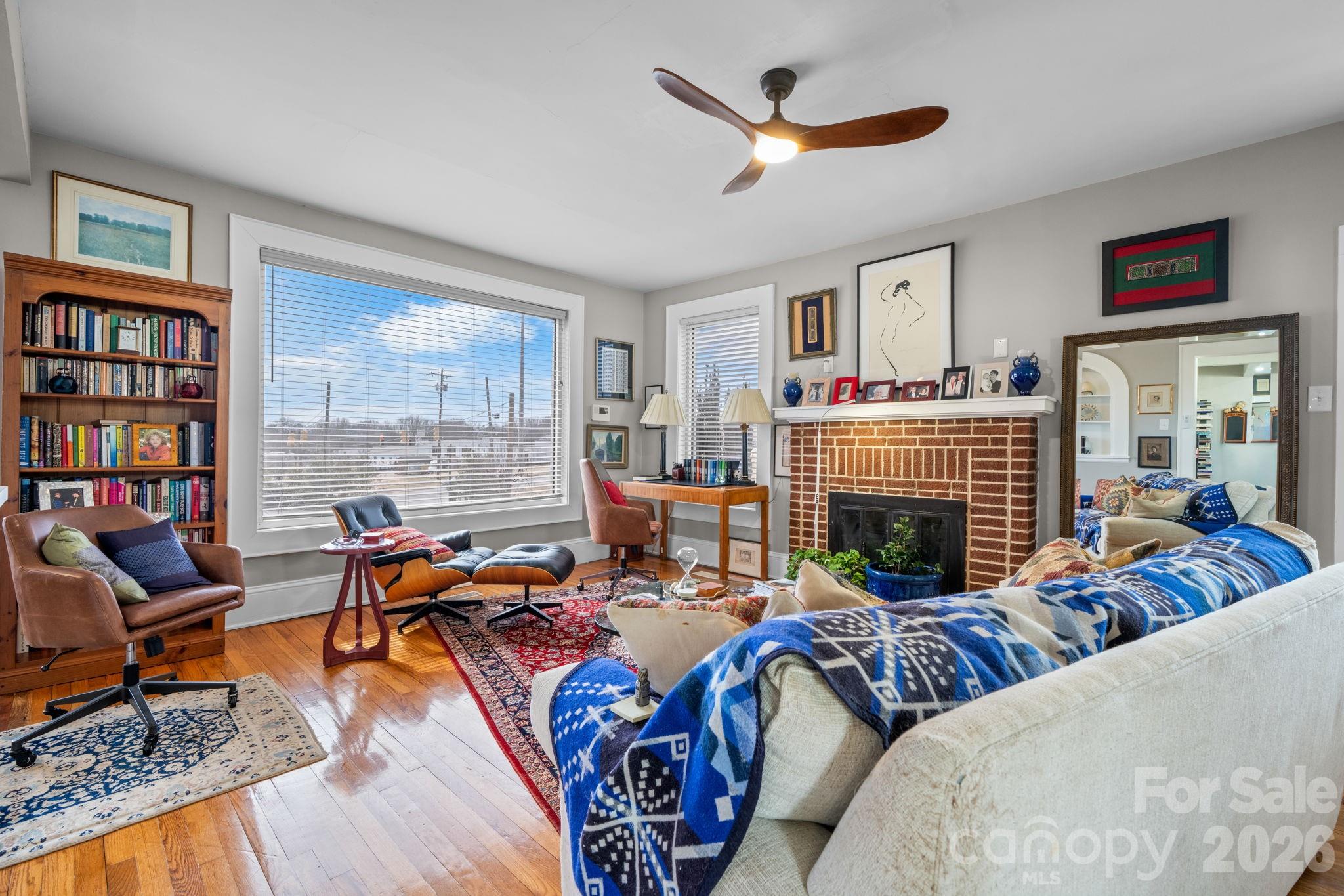 115 12th Street Southwest Hickory, NC 28602 - Photo 5 of 35 a living room with furniture fireplace and a large window