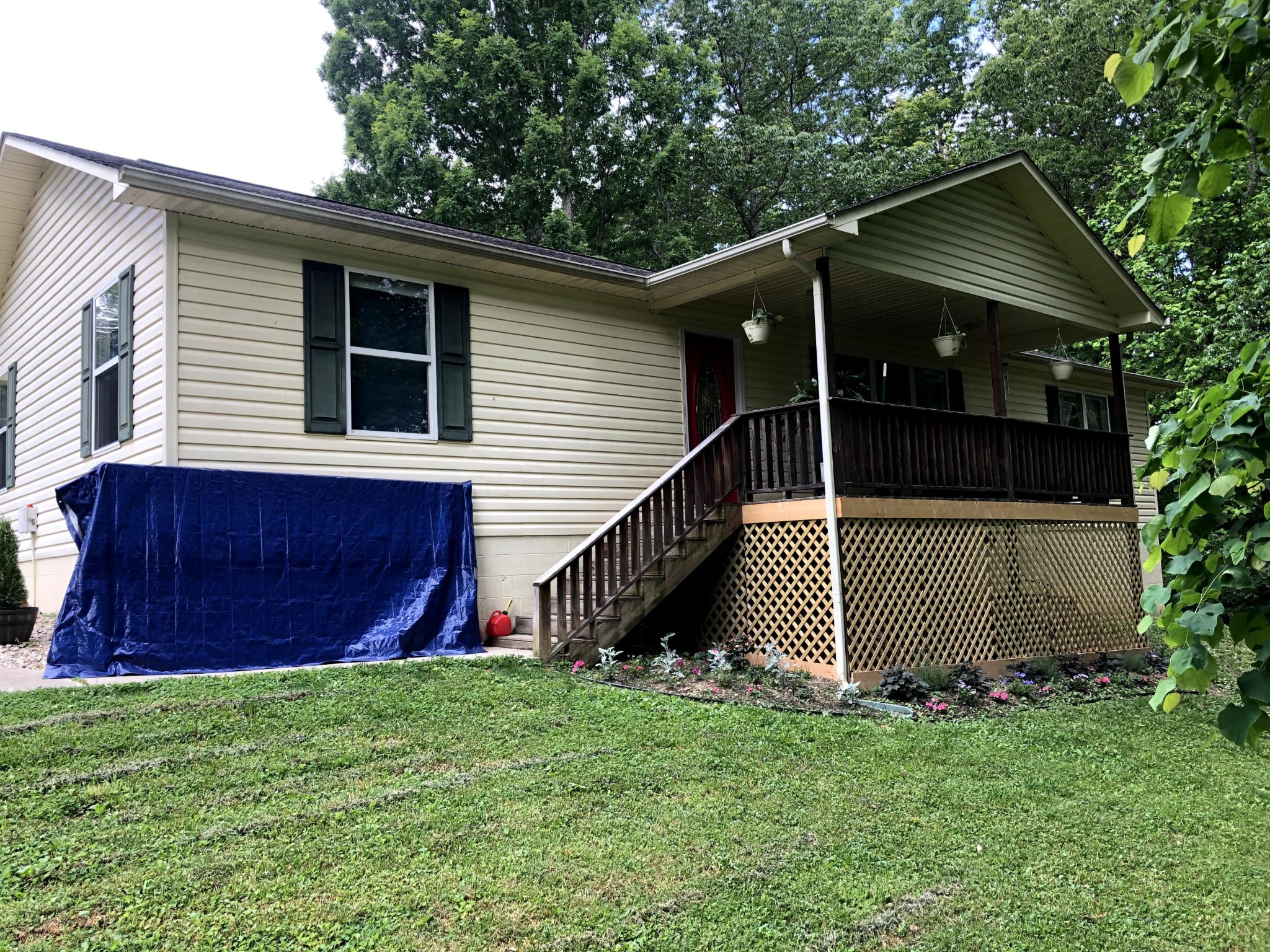 915 Sand Cut Road Oneida, TN 37841 - Photo 2 of 19 a view of backyard of house with wooden fence and a large tree