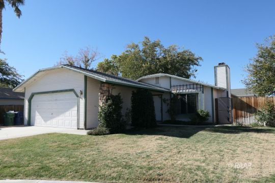 609 Heather Court Ridgecrest, CA 93555 - Photo 1 of 25 a front view of a house with a yard and garage