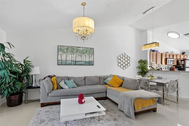 a living room with furniture and potted plant