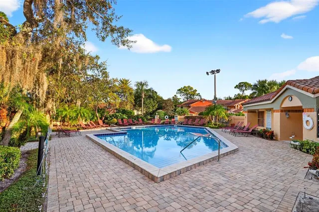 a view of a backyard with a tub and trees in the background