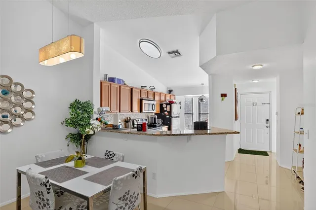 a view of living room with furniture and a potted plant