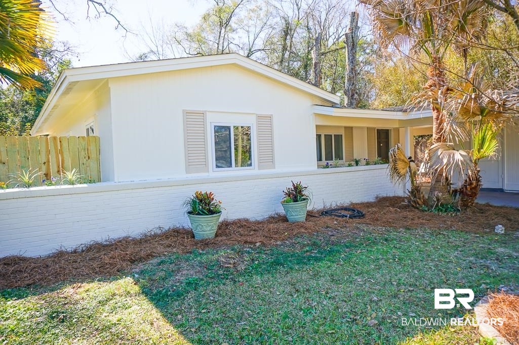 4159 Rebecca Road Mobile, AL 36609 - Photo 2 of 19 View of side of home with brick siding and fence