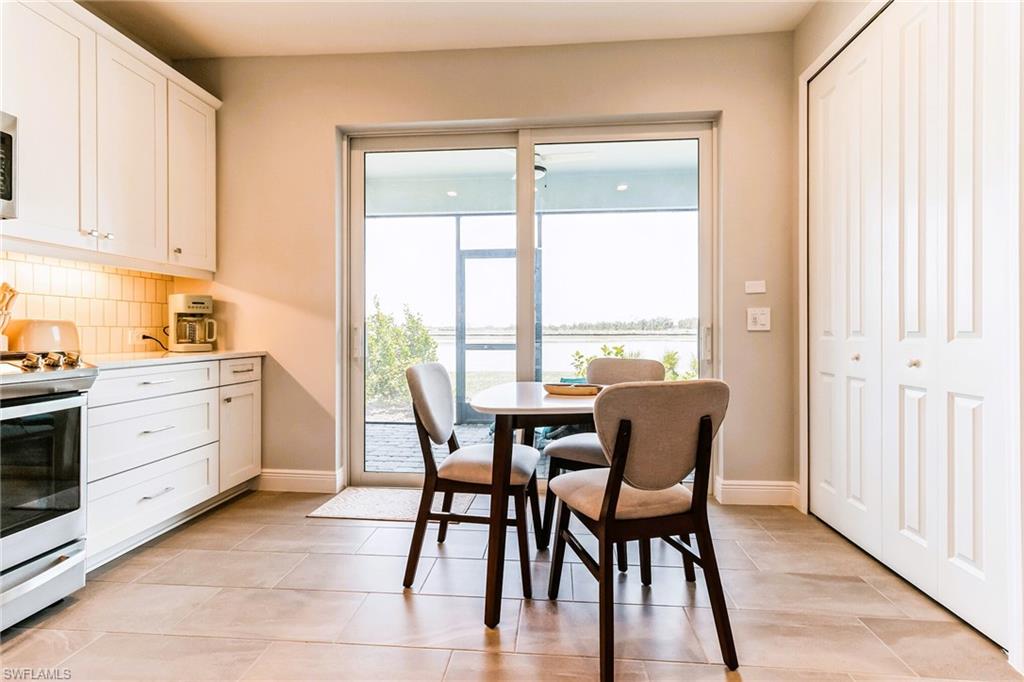 4664 Centaurus Circle Naples, FL 34120 - Photo 11 of 37 a view of a dining room with furniture window and outside view