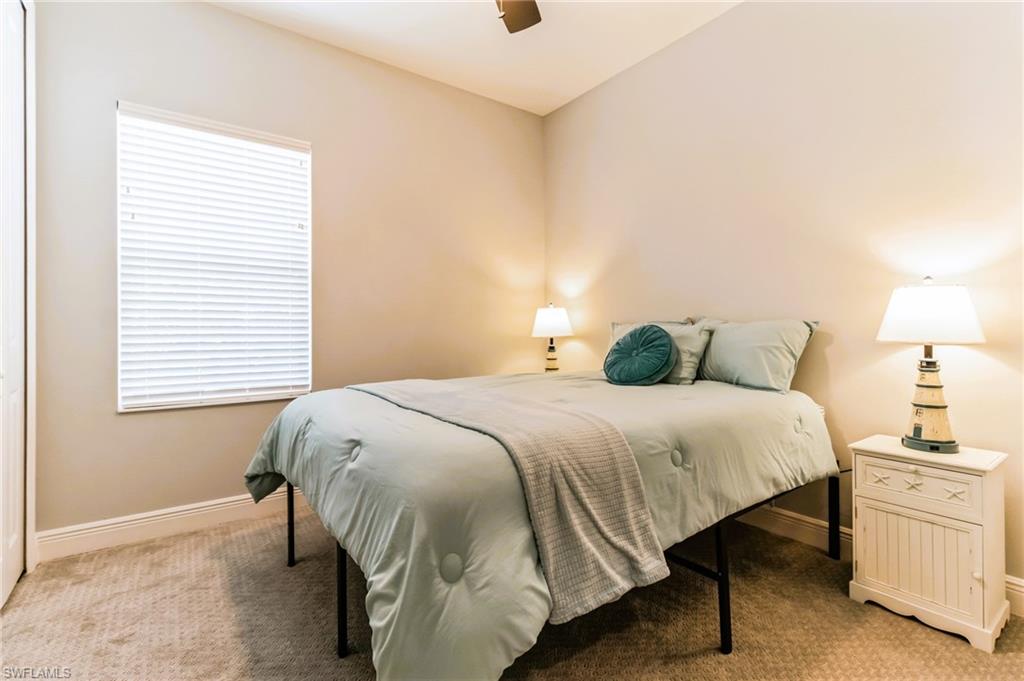 4664 Centaurus Circle Naples, FL 34120 - Photo 21 of 37 a bedroom with a bed and a window