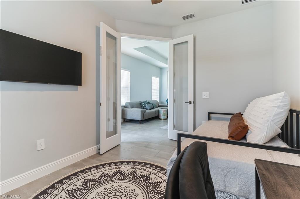 4664 Centaurus Circle Naples, FL 34120 - Photo 24 of 37 a living room with furniture and a flat screen tv
