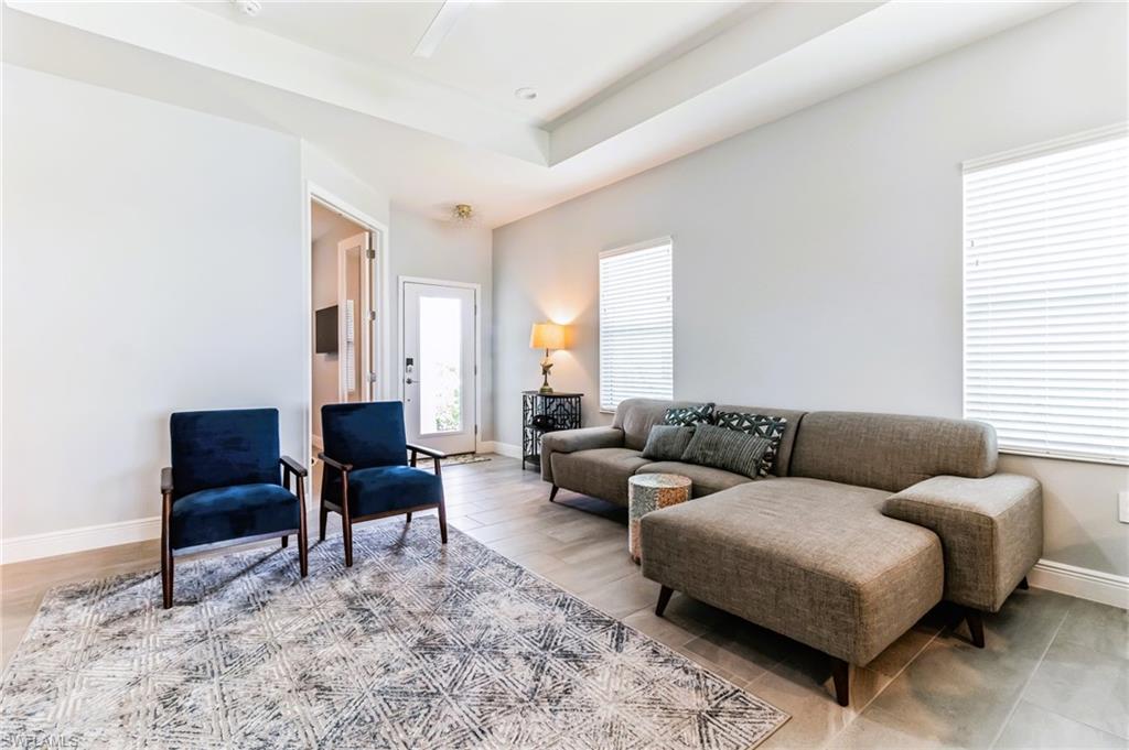 4664 Centaurus Circle Naples, FL 34120 - Photo 6 of 37 a living room with furniture and a rug