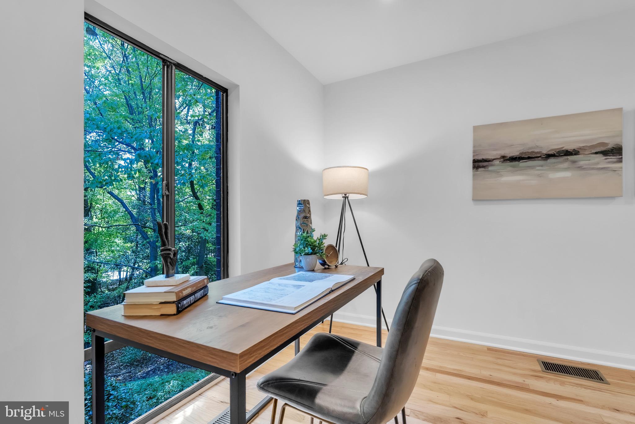 8074 Inverness Ridge Road Potomac, MD 20854 - Photo 12 of 41 a view of a workspace with a table and chair in a room