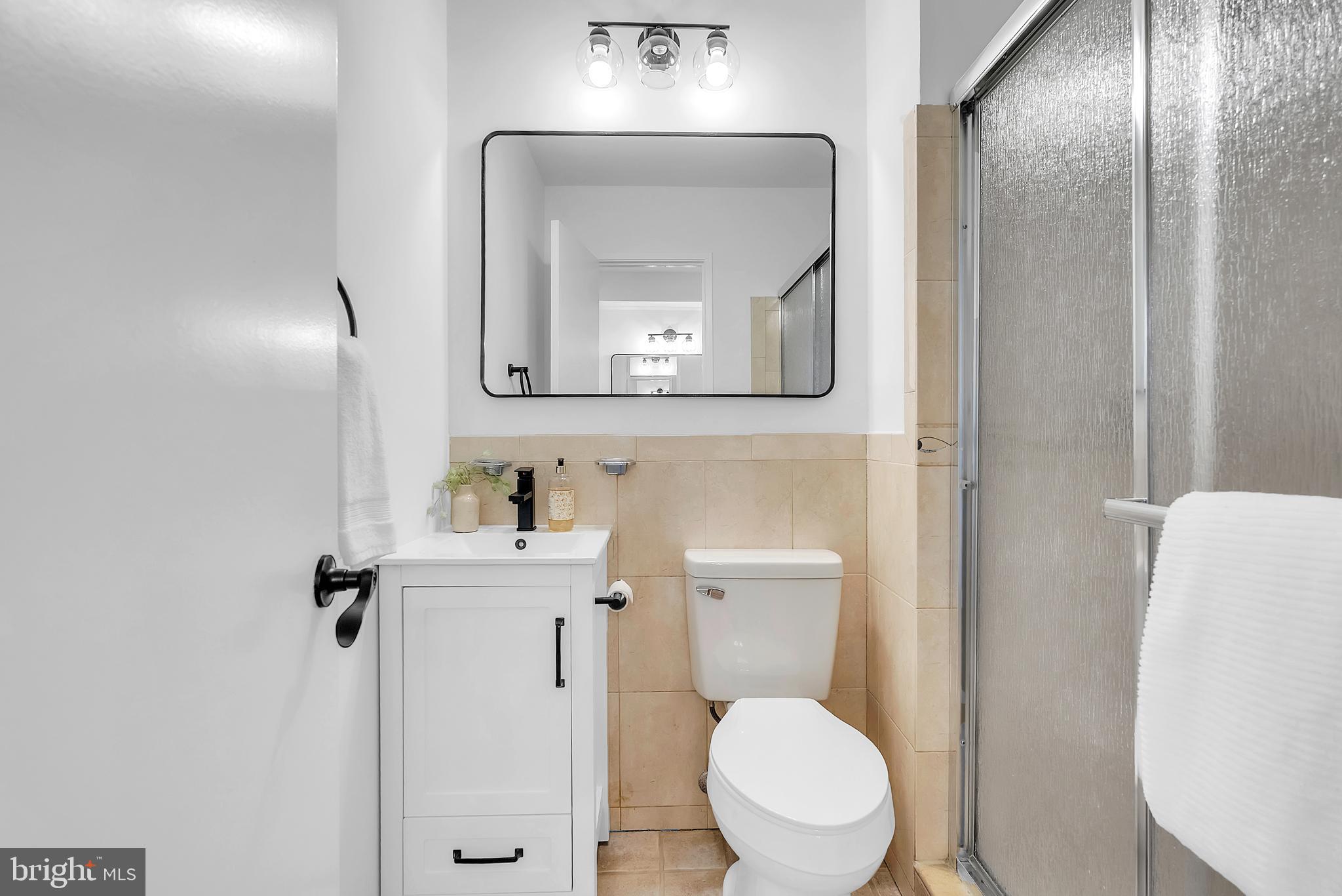 8074 Inverness Ridge Road Potomac, MD 20854 - Photo 20 of 41 a white toilet sitting next to a bathroom sink