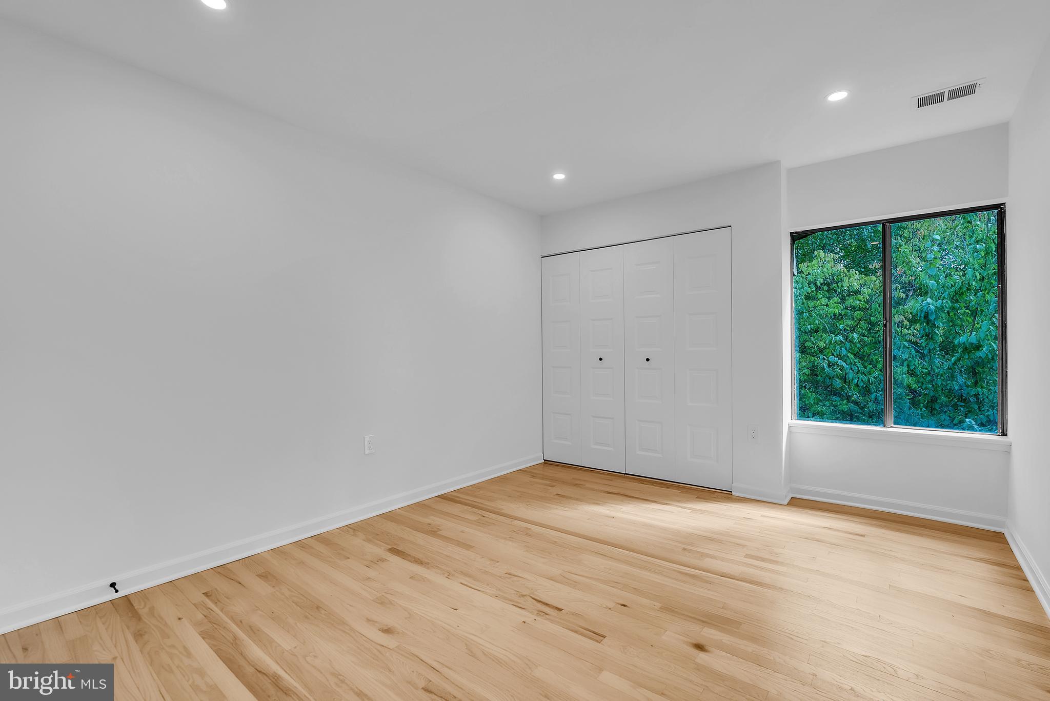 8074 Inverness Ridge Road Potomac, MD 20854 - Photo 22 of 41 a view of empty room with wooden floor and fan