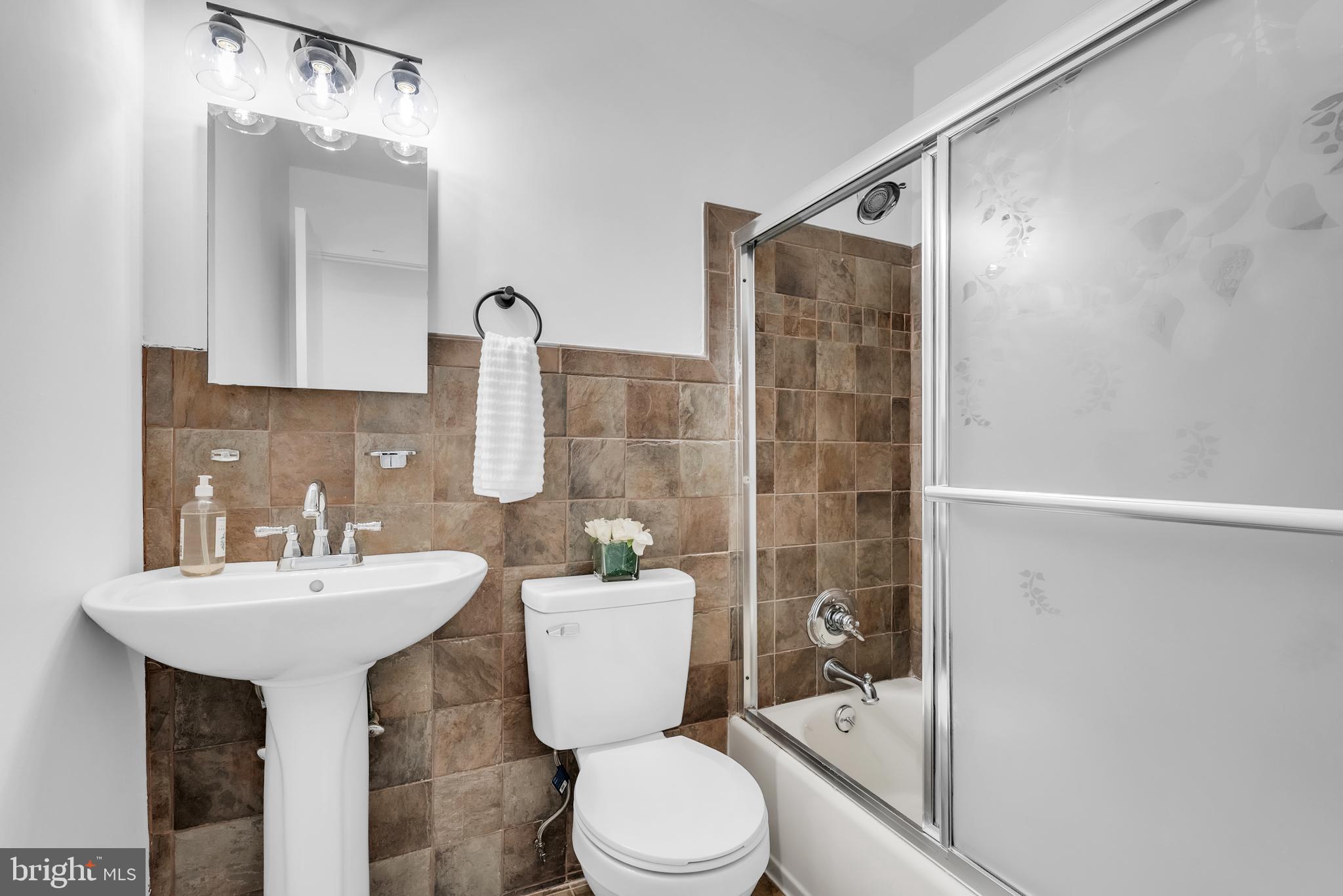 8074 Inverness Ridge Road Potomac, MD 20854 - Photo 26 of 41 a bathroom with a sink toilet and shower