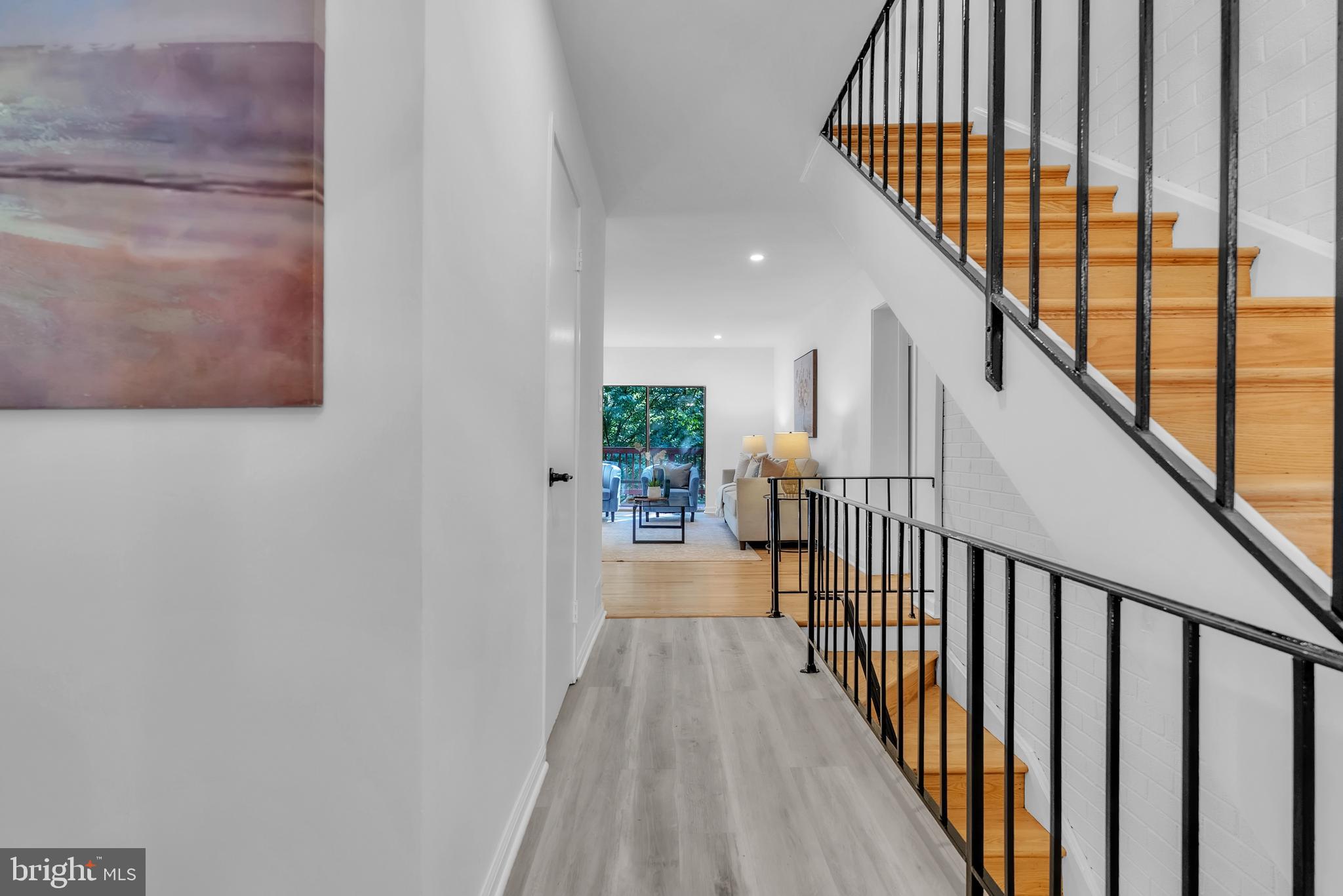 8074 Inverness Ridge Road Potomac, MD 20854 - Photo 3 of 41 a view of a hallway with wooden floor and staircase