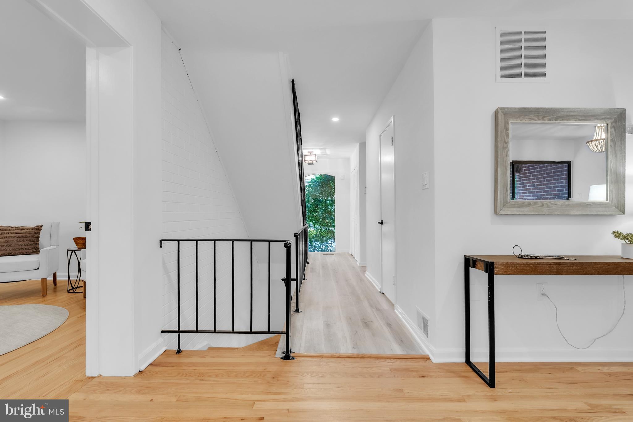 8074 Inverness Ridge Road Potomac, MD 20854 - Photo 4 of 41 a view of a hallway with wooden floor and a bathroom