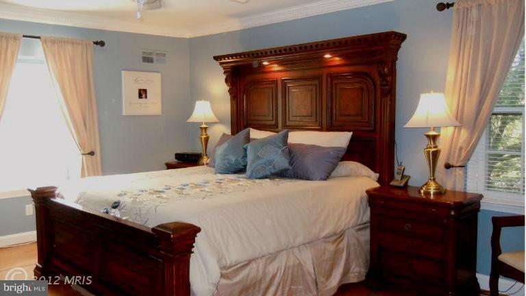 15613 Jones Lane Gaithersburg, MD 20878 - Photo 11 of 21 a bed sitting in a bedroom next to a window