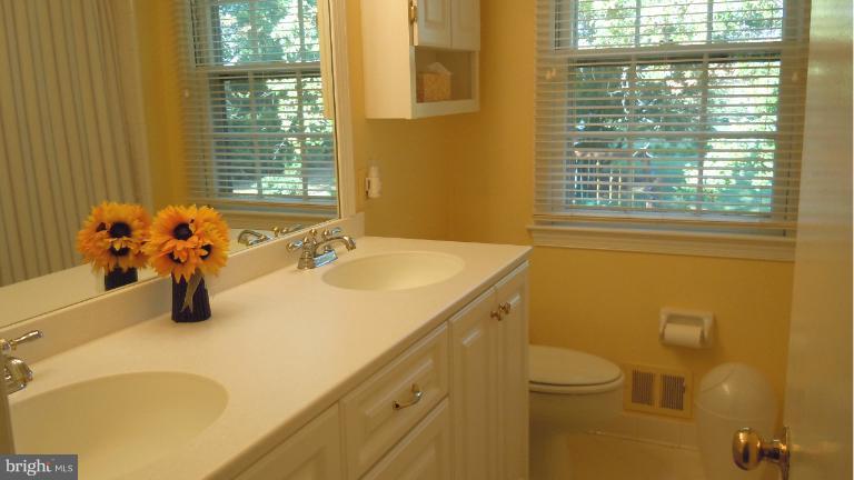 15613 Jones Lane Gaithersburg, MD 20878 - Photo 13 of 21 a bathroom with a sink a toilet and a mirror